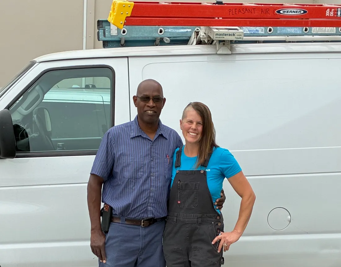 Two Pleasant Air Company technicians in front of the service van