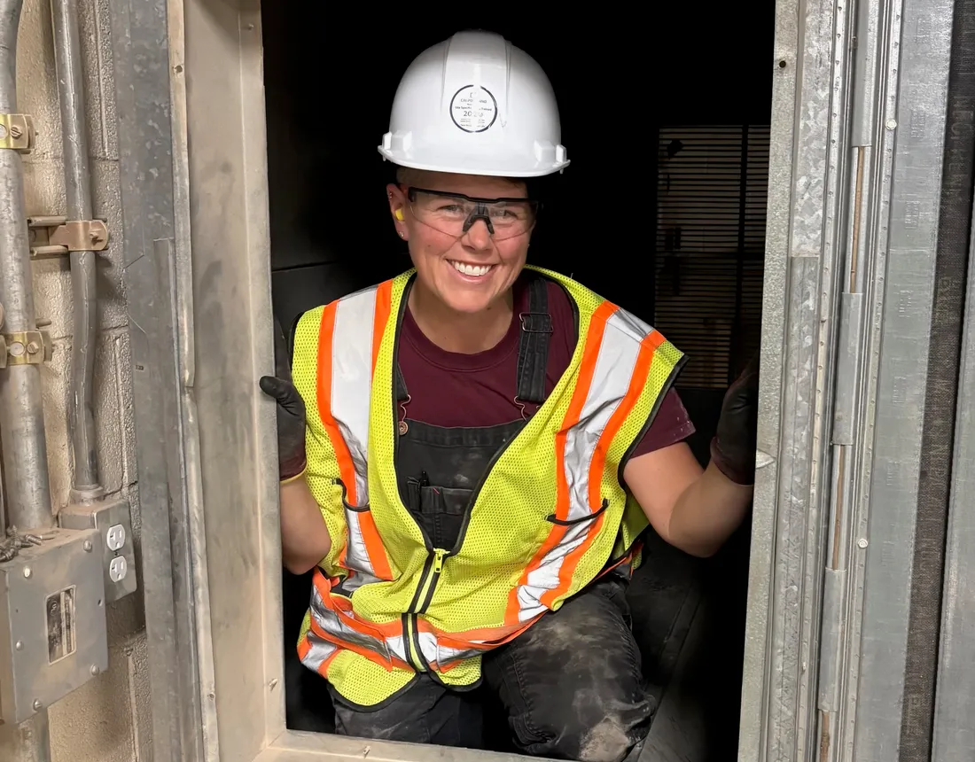 Pleasant Air technician looking out from inside an air handler while sizing up its filter bank
